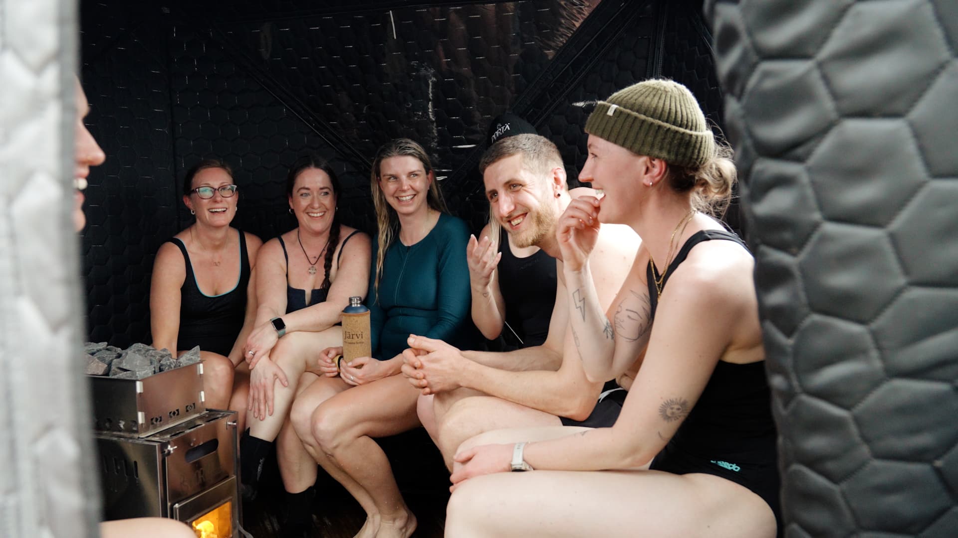 Group of friends enjoying a sauna session inside the Buff Rock Wellness portable sauna tent